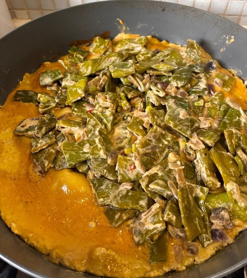 Omelet with sambal goreng in the pan